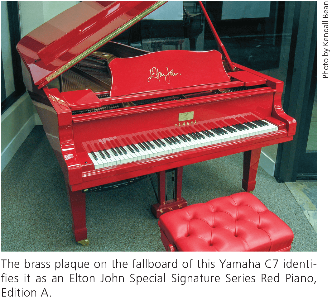 The brass plaque on the fallboard of this Yamaha C7 identifies it as an Elton John Special Signature Series Red Piano, Edition A.