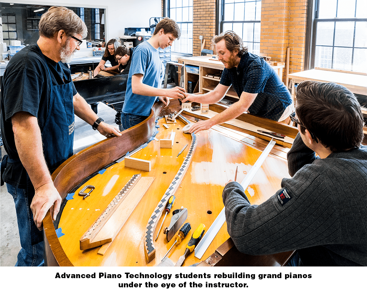 Advanced Piano Technology students rebuilding grand pianos under the eye of the instructor
