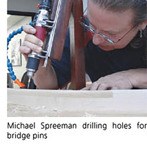 Michael Spreeman drilling holes for bridge pins