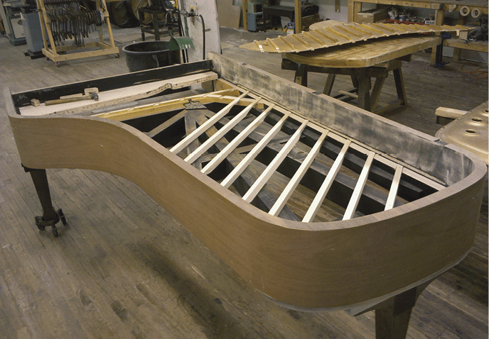 >Soundboards ribs are positioned in the shelf of the inner rim, waiting to be glued to a new soundboard.