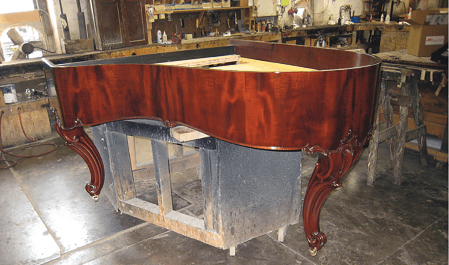 A Louis XVI-style Steinway grand receiving a new finish in the Cunningham shop.