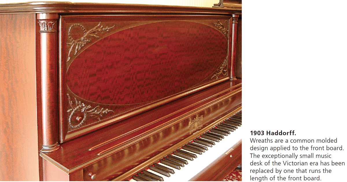 1903 Haddorff. Wreaths are a common molded design applied to the front board. The exceptionally small music desk of the Victorian era has been replaced by one that runs the length of the front board.