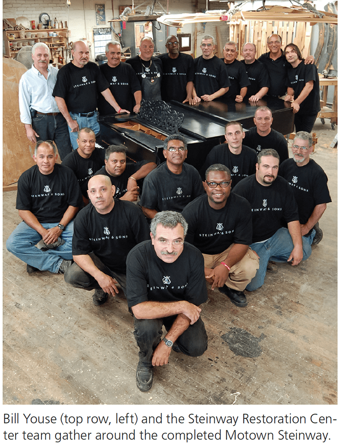 Bill Youse (top row, left) and the Steinway Restoration Center team gather around the completed Motown Steinway.